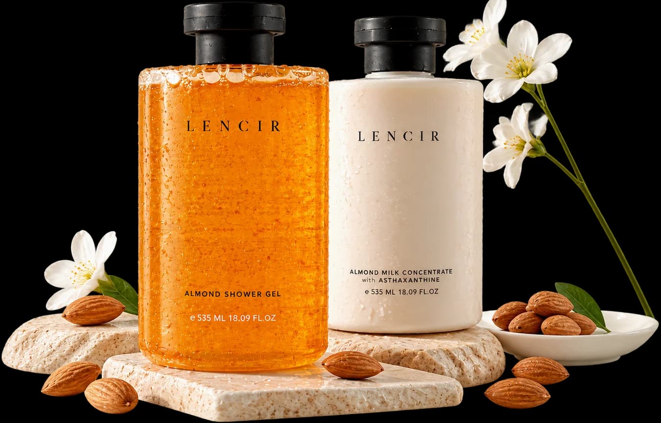 Lencir Almond Shower Gel dan Almond Milk Concentrate dengan Astaxanthin di atas batu, dikelilingi almond dan bunga.